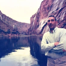 Stewart L. Udall posing on the banks of the Colorado River